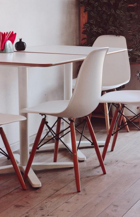 Two White Loo Tables With Four Chairs