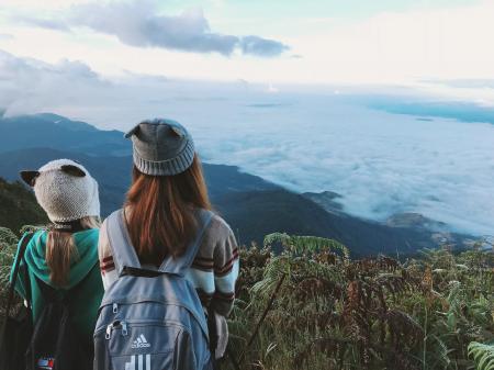 Two Woman Wearing White and Gray Crater Hat