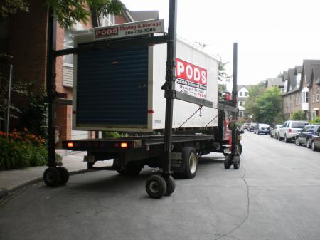 Unloading a shipping container with household contents -f