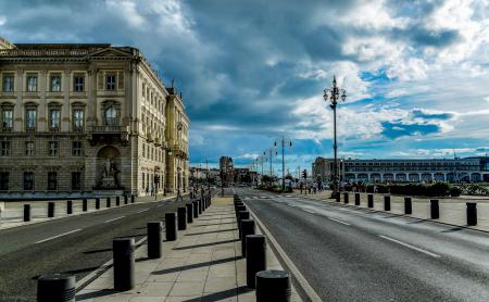 View of City Street Against Cloudy Sky