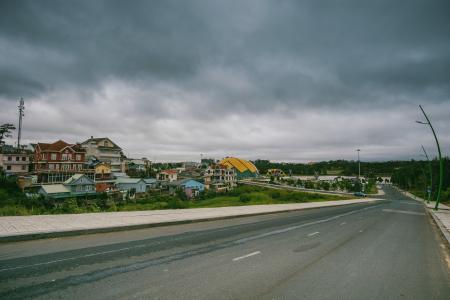 Village Beside Road Under Cloudy Sky