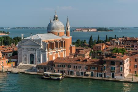 White and Beige Structure Building and Cathedral Near Body of Water during Daytime