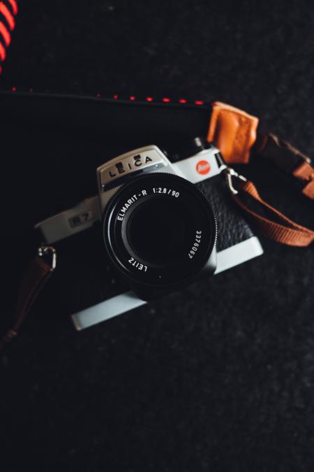 White and Black Leica Camera on Black Textile