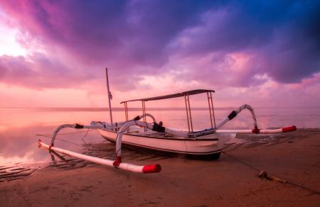 White and Black Motor Boar on Shore at Sunset