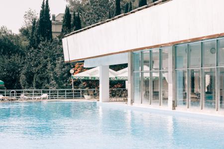 White and Gray Concrete Building Near Blue Swimming Pool