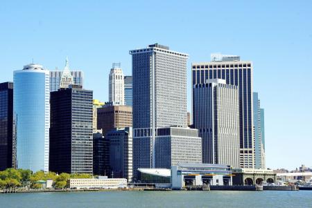 White and Gray High Rise Buildings Near Body of Water