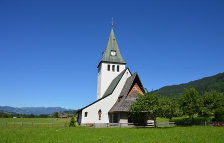 White and Gray Painted Chapel Near Green Open Field during Daytime