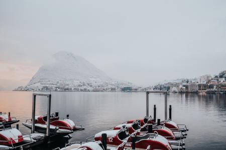 White and Red Boats on Dock Near White Snowy Mountain