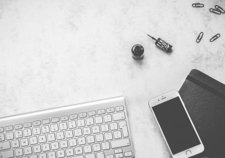 White Android Smartphone and Computer Keyboard