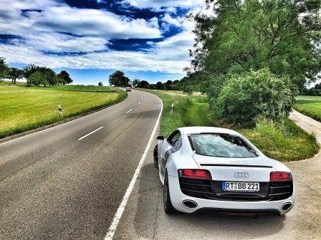 White Audi Coupe on Gray Concrete Road during Textile