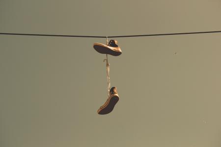 White Black High Top Shoes Hanging on Electric Line