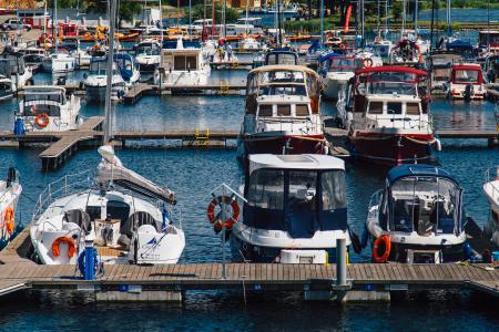 White Blue Sailboats Dock on Water during Daytime