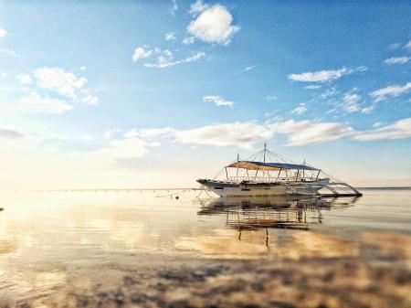 White Boat on Sea during Sunrise