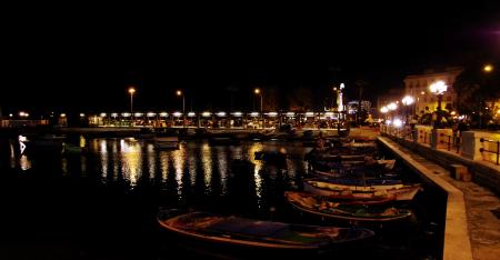 White Boats Near Gray Post Light during Night Time