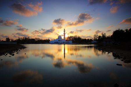 White Building Surrounded by Water and Trees during Golden Hour