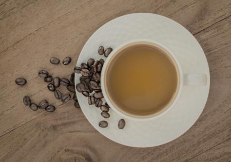 White Ceramic Coffee Cup on Brown Wooden Panel