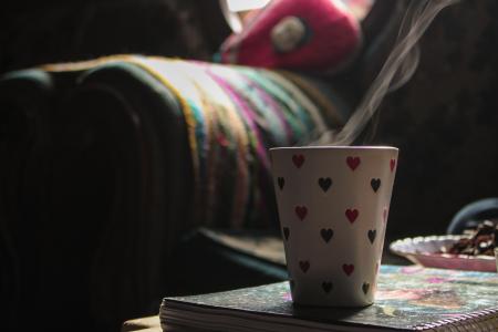 White Ceramic Cup on Book