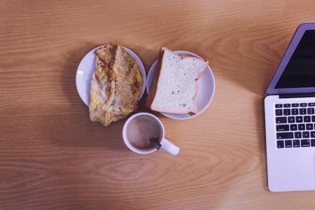 White Ceramic Mug Beside Bread on White Ceramic Saucer