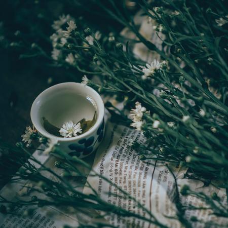 White Ceramic Mug Beside White Petal Flower