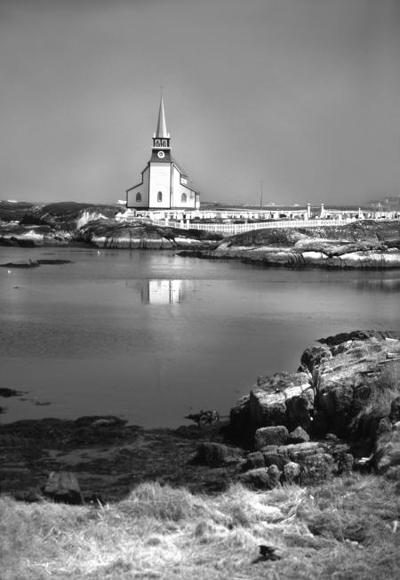 White Church Next to Body of Water