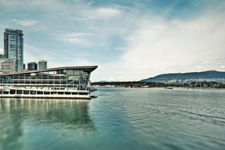 White Concrete Building Near Body of Water Under Blue Sky