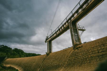 White Concrete Dam With Bridge