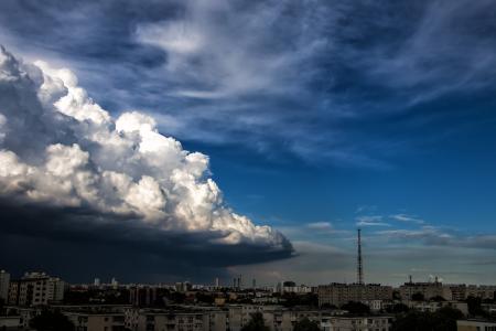 White Concrete High Rise Building Under Gray White Clouds during Daytime