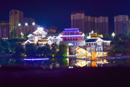 White Concrete House Beside Large Body of Water during Nightime