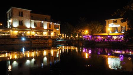 White Concrete Lighted Building Near Body of Water during Nighttime