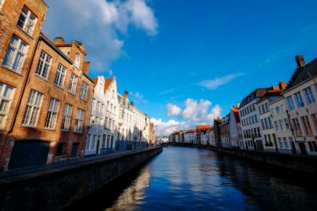 White Concrete Storey Building Near Body of Water