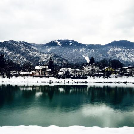 White Houses in Front of Mountains Under White Cloudy Sky