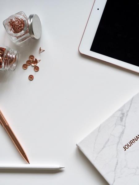 White Ipad On The Table Near Small Clear Glass Jars