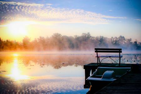 White Plastic Boat on Lake Beside Wooden Dock during Golden Hour