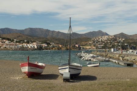 White Red and Black Sail Boat on Gray Sand