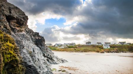 White Sand Beside Grey Rock Cliff