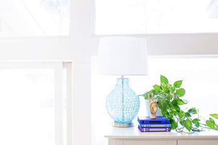 White Table Lamp on Sideboard Near Plant and Books