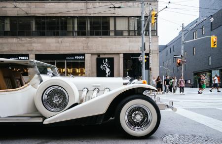 White Vehicle Near Gray Lamp Post and Brown Building Structure