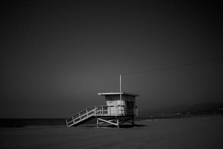 White Wooden Lifeguard House Near Shoreline