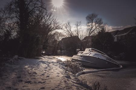 White Yacht on Snowy Pavement