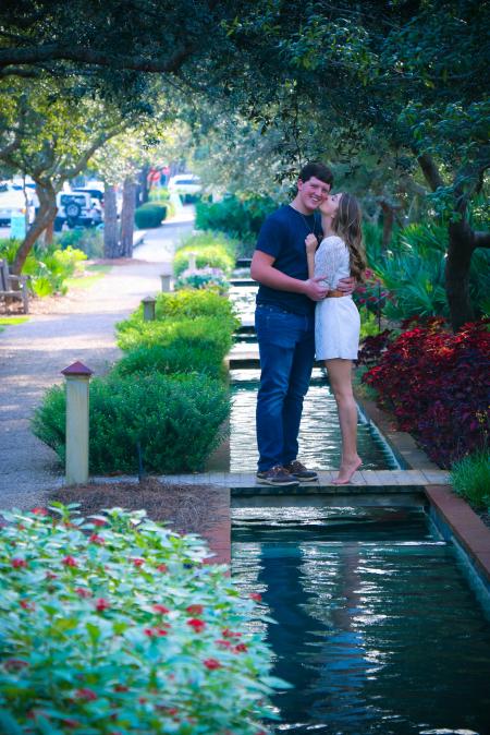 Woman and Man Standing on Bridge Kissing