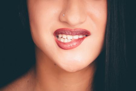 Woman Biting Red Lips With Nose Pin