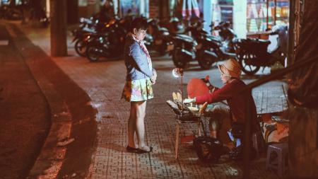 Woman buying from a street vendor