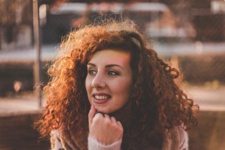 Woman Curly Hair With White Long-sleeved Top