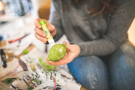 Woman decorating egg for Easter
