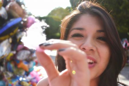 Woman Doing Holding Cotton Candy In Front Of The Camera