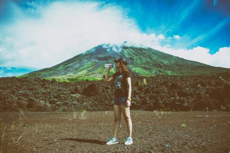 Woman Drinking Water Beside Mountain