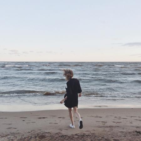 Woman Going Toward the Sea Under Clear Skies