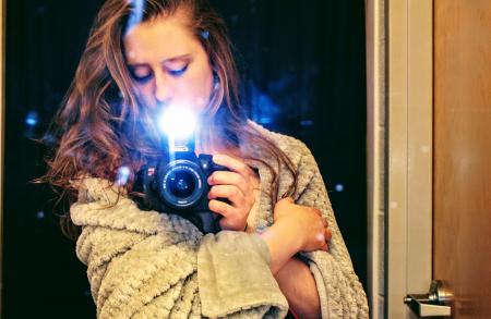 Woman Holding a Black Dslr Camera