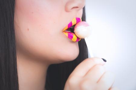 Woman Holding a Lollipop