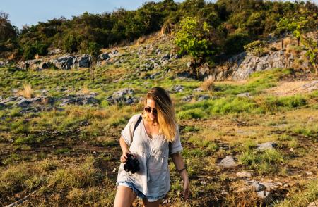 Woman Holding Black Dslr Camera Near Forest